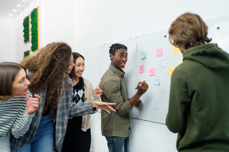Creative business team reading the sticky notes and discussing.の写真素材