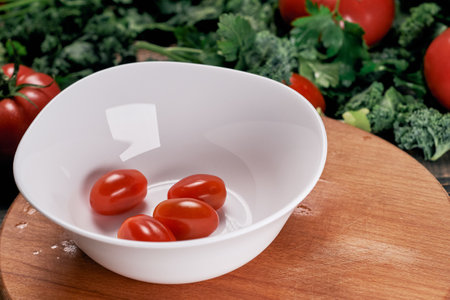 plate of tomatoes on a wooden kitchen board.の写真素材