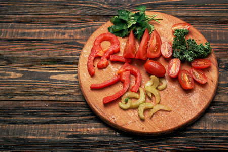 sliced vegetables on a round wooden board.の写真素材