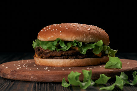image of a burger with a chicken cutlet on a wooden board.の写真素材