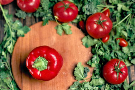 red pepper and fresh tomatoes on a wooden background.の写真素材