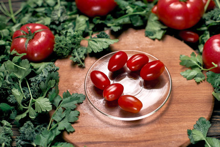 fresh red tomatoes on a glass plate.の写真素材