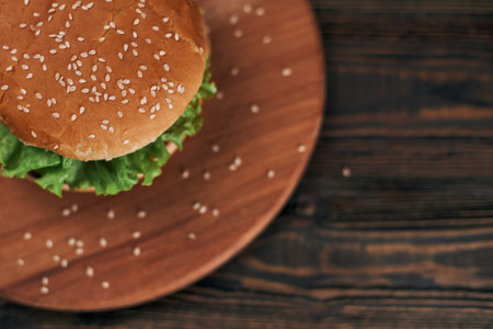 delicious burger on a wooden chopping board.の写真素材