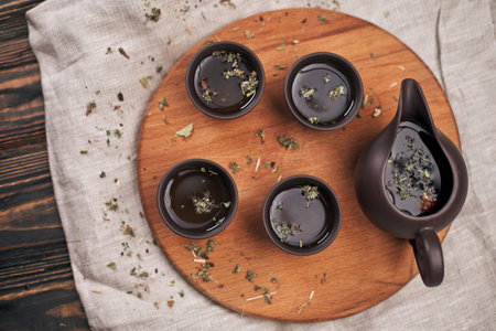 tea set and green tea leaves on a wooden boardの写真素材