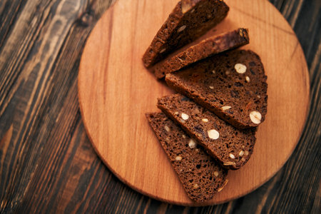 sliced whole-grain bread on a wooden board.の写真素材