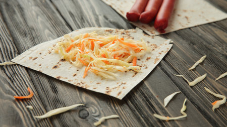 sausage, cabbage and pita bread isolated on wooden backgroundの写真素材