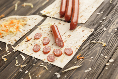 sausages, pickled cabbage and pita bread on wooden backgroundの写真素材