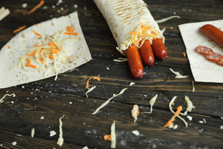 sausages in pita bread on the table by the chefの写真素材