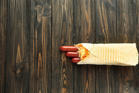 German sausages in pita bread on a dark wooden background.photo with copy spaceの写真素材