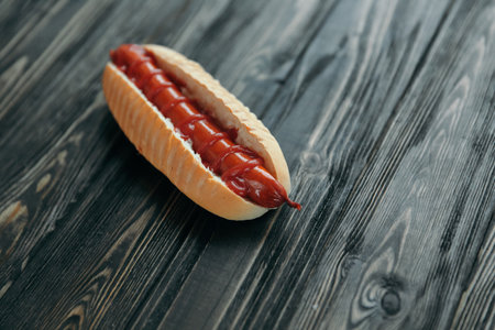 hot dog with smoked sausage on dark wooden background.photo with copy spaceの写真素材