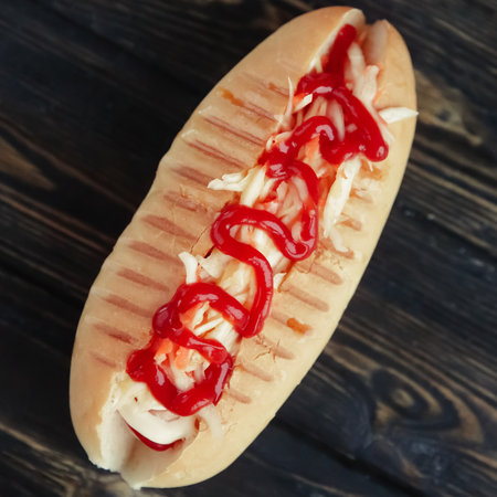hot dog with spicy sauce on dark background.photo with copy spaceの写真素材