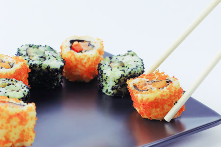 Sushi and rolls. the set is served on a black plateの写真素材