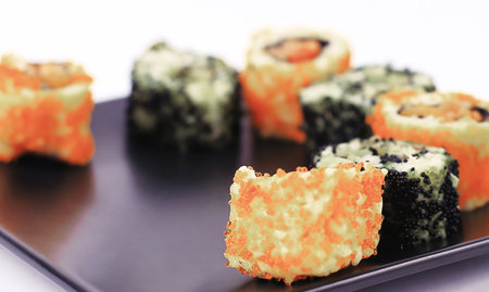 set of Sushi rolls on black plateの写真素材