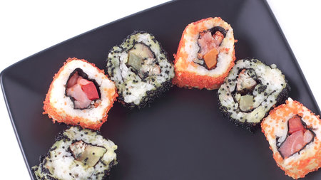 set of Sushi rolls on black plateの写真素材