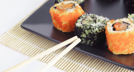 Sushi Set - different types of Maki sushi and chopsticks on a bの写真素材
