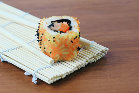 sushi rolls and chopsticks on wooden background.の写真素材
