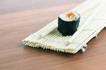 sushi rolls and chopsticks on wooden background.の写真素材
