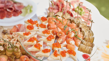 red caviar and salmon rolls with cottage cheese on the holiday tableの写真素材