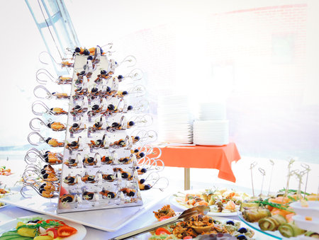 catering table set service with silverware and glassの写真素材