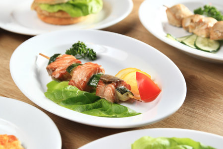 kebab, Burger and salads on the tableの写真素材