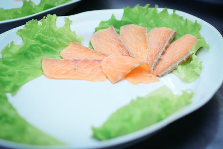 dishes with red fish on the table in the kitchen of the restaurantの写真素材