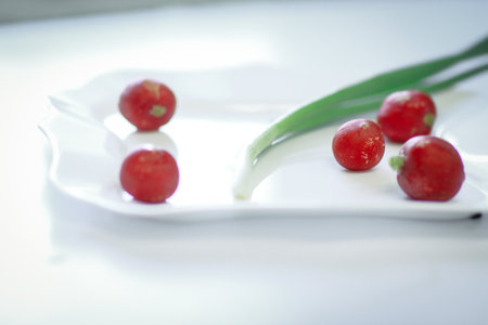 radish and green onion on light backgroundの写真素材