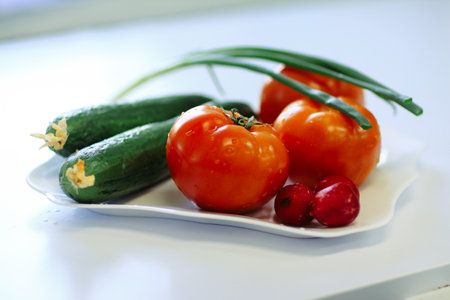 close up.radishes, tomatoes and cucumbers on the tableの写真素材