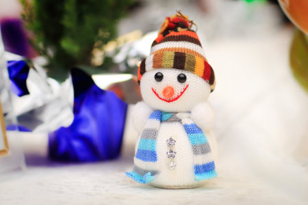 cheerful snowman and Christmas decorations on the Christmas tableの写真素材
