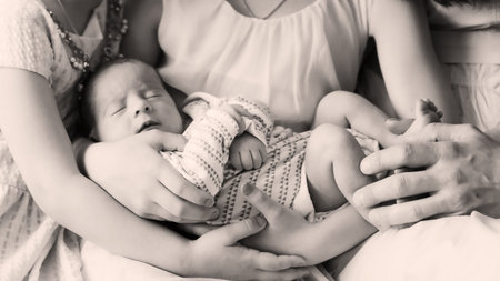 happy family and a newborn baby in the hands of his older sister. black and white photo