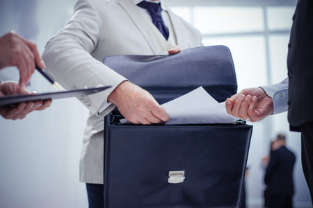 close up. businessman taking out of his briefcase business documents.の写真素材