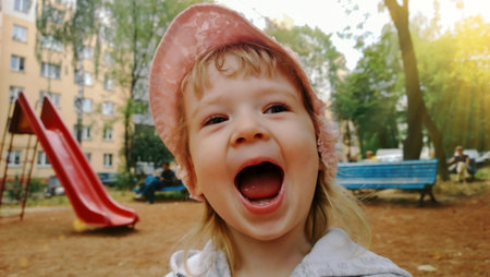 cheerful little girl on Playground in summer dayの写真素材