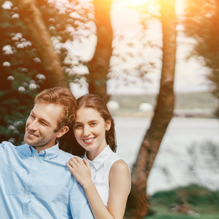 image of a young couple on a walk along the lake shore.の写真素材