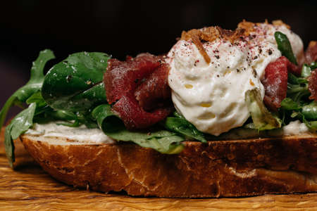 Front view close up bruschetta on crispy fresh bread with marbled beefの写真素材