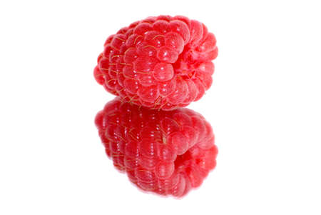Berry of a raspberry are reflected in a mirrorの写真素材