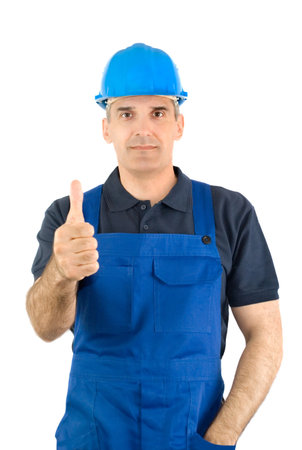 The worker in a blue overalls and a blue helmet shows the big fingerの写真素材