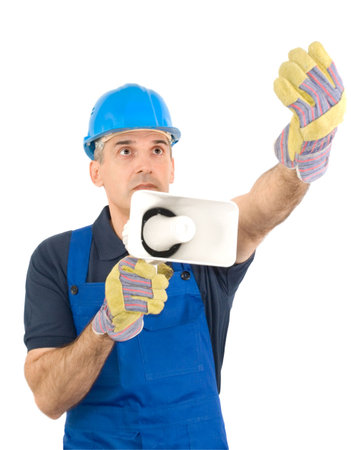 The worker in a blue overalls and a blue helmet with a megaphoneの写真素材