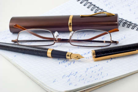 Spectacle-case, eyeglasses, pen are photographed on a writing-book with formulas

の写真素材