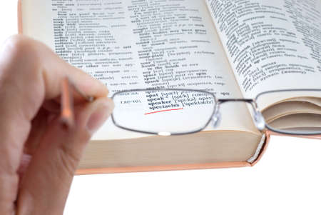 Glance at the dictionary through spectaclesの写真素材