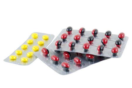 Yellow and black-red pills are photographed a close-up