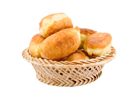 Fried pies in a wicker backet are photographed on the white backgroundの写真素材