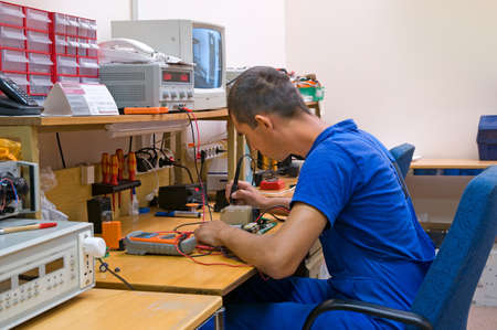 The electrician is engaged in repair of an electric equipment