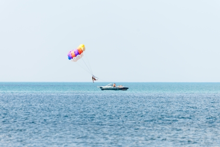 Vacationers try out the water sport of parasailingの写真素材