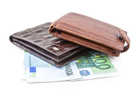 The two brown  leather wallet with euro and dollars is photographed on the close-upの写真素材