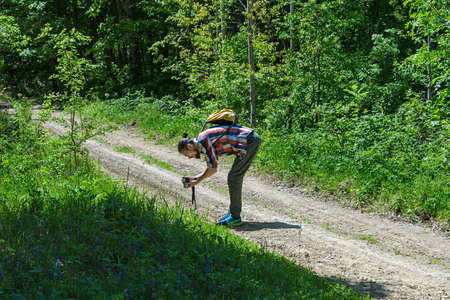 Photographer at work on a forest roadの写真素材