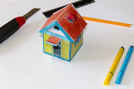 A small paper house. A house glued from paper, painted with felt-tip pens. Paper and cardboard productsの写真素材