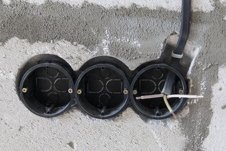 Installation of sockets during the construction of a house. Triple socket is installed in a niche. A...