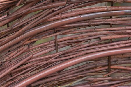 The technique of making a wicker bench around a metal frame painted in colorの写真素材