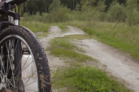 Front tire of a bicycle. Out of town cycling on dirt roads