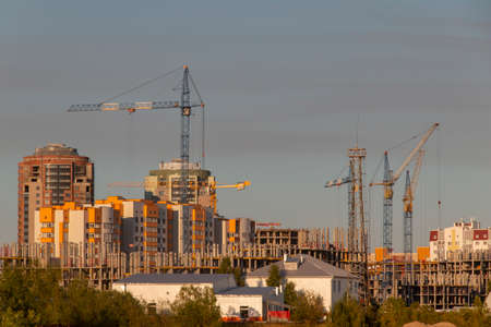 View of the extensive construction of modern buildings. Tower cranes and mass of building structures