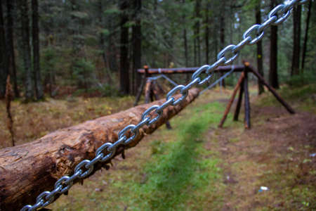 A sports equipment for walking on a log, built in the forest from wood and chains. Competition Obstacle Courseの写真素材